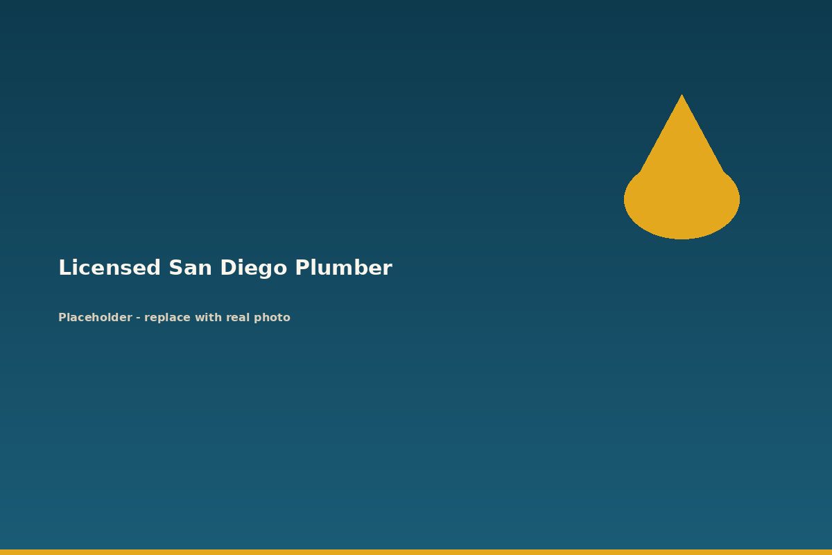 Licensed plumber tightening a fitting under a sink during a repair in San Diego